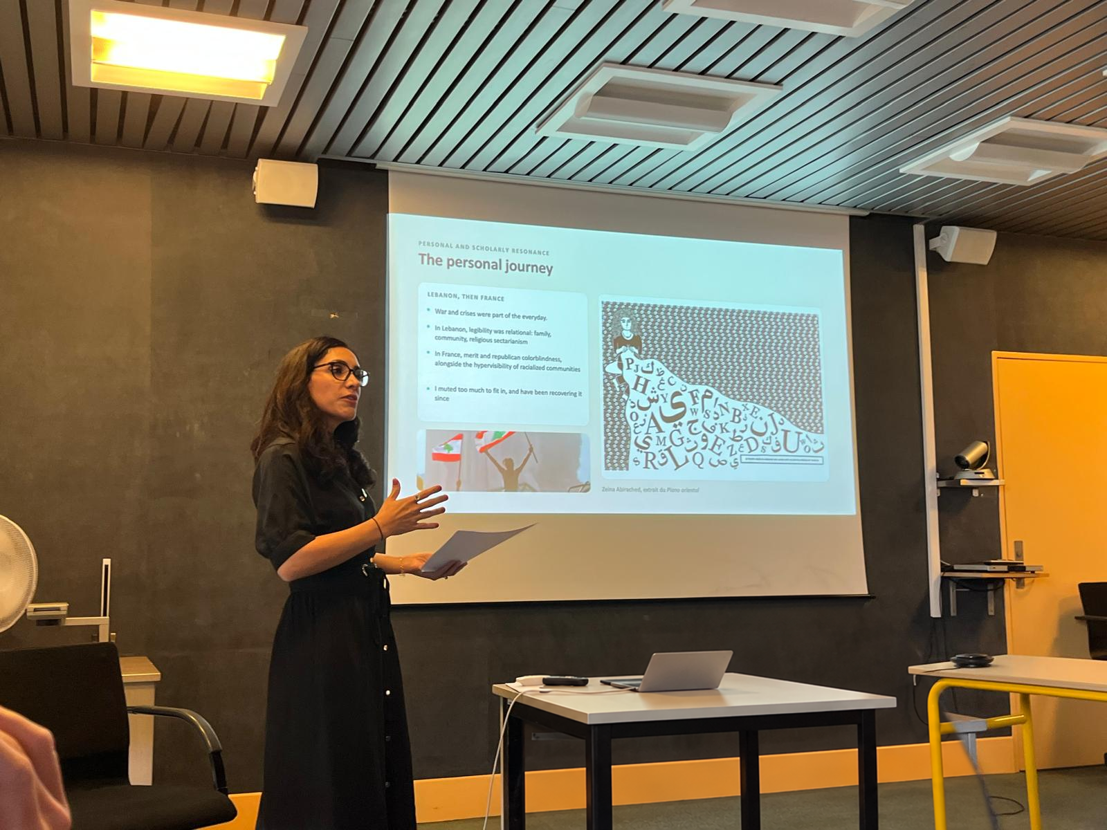 Farah Kodeih presenting her personal journey during her HDR defense, with Lebanese flags visible on the slide