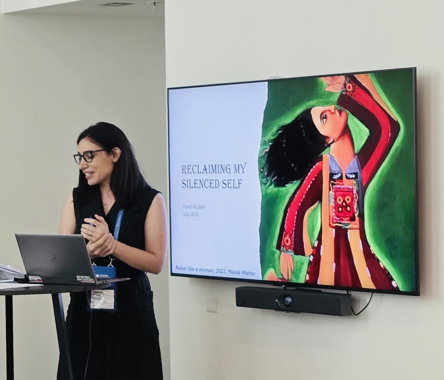 Farah Kodeih presenting Reclaiming My Silenced Self, with the illustrated slide visible