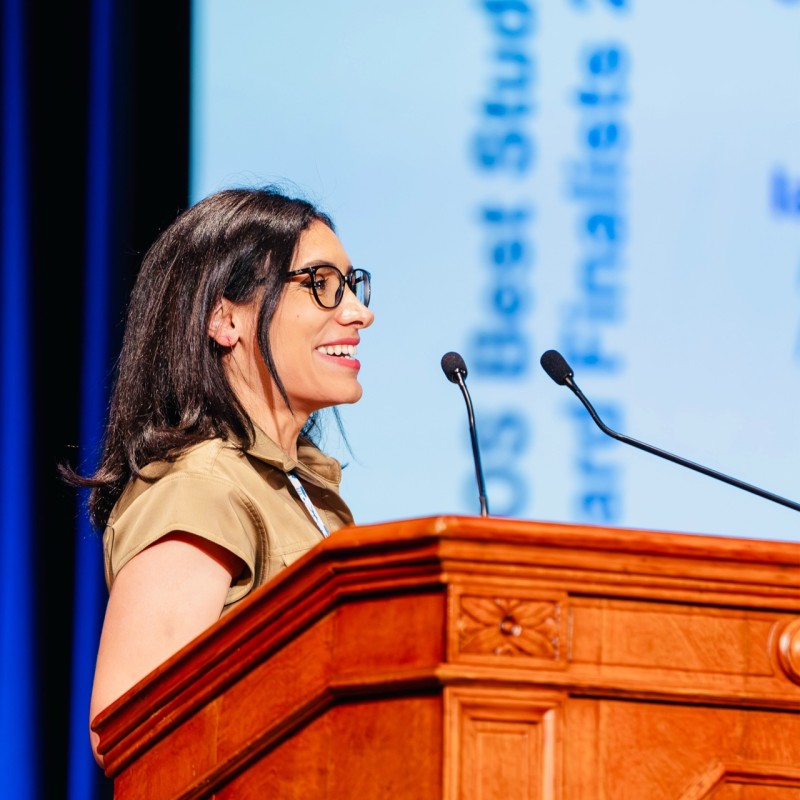 Farah Kodeih smiling while speaking at a lectern